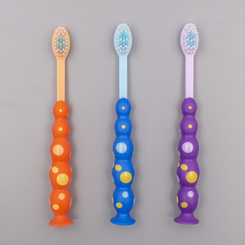 Cepillo de dientes con lunares para niños con succión